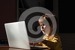Cybercrime concept. Male hacker working on a computer in Data center filled with monitor screens. Kids using laptop in photo