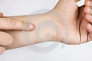 The man shows his hand with a chip implanted. The concept of chipping and implantation of electronic technologies into the human photo