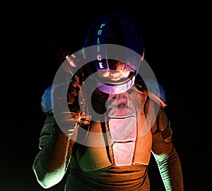 Cyberpunk concept, future world. Police officer cop in dark, halfman bionic cyborg or reloads gun, twitches cocking lever, Stands