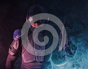 Cyberpunk concept, future world. Police officer cop in dark, halfman bionic cyborg or reloads gun, twitches cocking lever, Stands photo