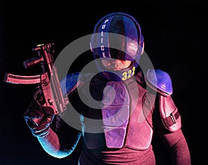 Cyberpunk concept, future world. Police officer cop in dark, halfman bionic cyborg or reloads gun, twitches cocking lever, Stands