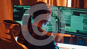 Cyberpunk girl backview types on keyboard multiple monitors with strings of code