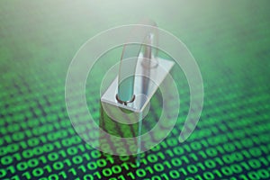 Cybersecurity concept with a padlock over binary code background.