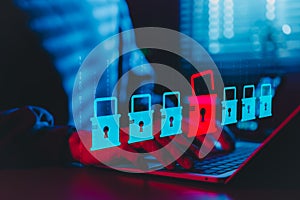 Cybersecurity and Data Breach Risk Concept. A person using laptop with digital padlock icons, red open lock symbolizing data photo