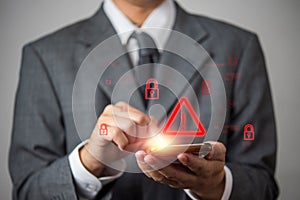 Cybersecurity warning concept with a businessman using a smartphone. Digital security threat, hacking risk, malware attack, and