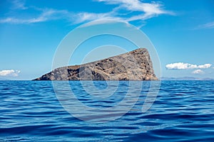 Cyclades Greece. Piperi rock, blue sky, rippled Aegean Sea between Kythnos and Serifos island