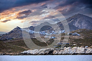 Cyclades Greece. Serifos island Chora town white building uphill on rocky land, sunset sky