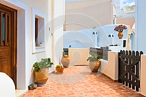 Cycladic architecture in Santorini island, Greece. Cozy courtyard with flowers