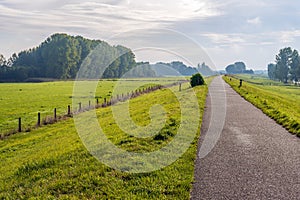 Cycle path on top of a dike along a river