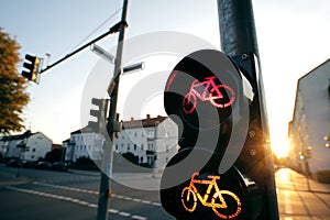 A cycle traffic light shows red and yellow light at an european intersection in uplifting and inspiring morning light