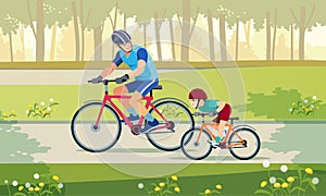 Cycling. Active holidays. Father and son are riding bikes in the park. Happy family is riding bikes outdoors and smiling