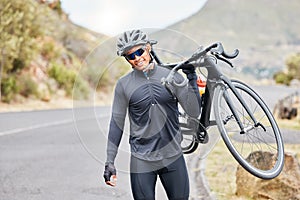 Cycling, bike trail and fitness man carrying his bicycle after riding along a countryside road. Happy male cyclist and