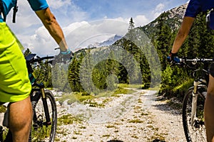 Cycling couple with bikes on track, Cortina d`Ampezzo, Dolomites