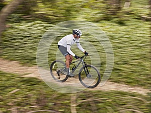 Cycling, fitness and man with mountain bike in forest for speed, training or nature workout with top view off road race