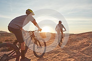 Cycling is always a good idea. Full length shot of two young male athletes mountain biking in the wilderness.