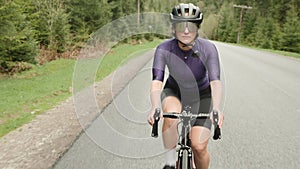 Cycling. Hard training. Woman cycling. Athlete preparing for bike race, training on bicycle. Cyclist workout exercises. Cardio fit