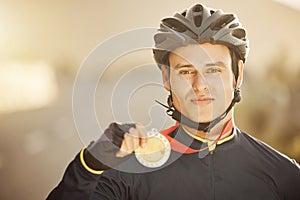 Cycling, helmet and medal with a sports man after a race as a winner, champion or medalist outside. Motivation