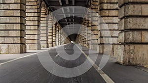 Cycling lanes running between arches of Pont de Bercy in Paris, time-lapse