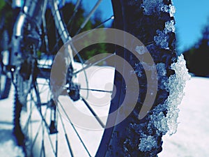 Cycling on large tyres in fresh snow. Biker goes by bike on the snowy road