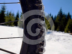 Cycling on large tyres in fresh snow. Biker goes by bike on the snowy road