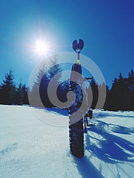 Cycling on large tyres in fresh snow. Biker goes by bike on the snowy road