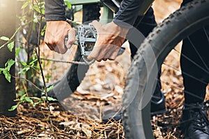 Cycling, maintenance and hands of man with mountain bike fix, service or repair wheel gear, chain or tire equipment