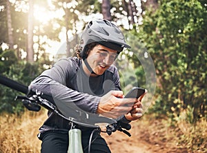 Cycling man in forest, phone gps and map direction with adventure, nature trail and bicycle break in woods. Happy