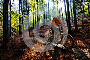 Cycling man riding on bike at sunset.