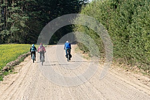 Cycling in nature. bike trip on a warm Sunny day on an empty dirt road. Road without cars along the forest. Weekend in nature with