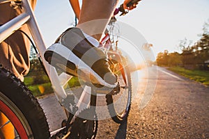 Cycling outdoors, close up of the feet on bicycle photo