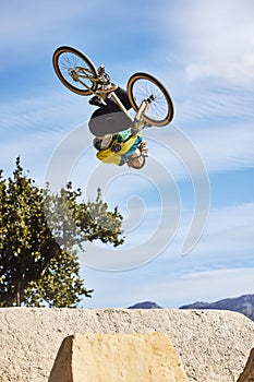 Cycling sports, bike and jump of man performing stunt outdoors in nature. Trick, dangerous risk and biker, rider or bmx