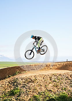 Cycling, sports and man in air on bicycle for adrenaline on adventure, freedom and jump for speed. Mountain bike, tricks