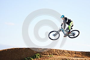 Cycling, sports and man jump with bicycle for adrenaline on adventure, freedom and in air for speed. Mountain bike