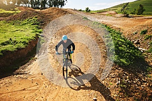 Cycling, sports and man in nature on bicycle for adrenaline on adventure, freedom and speed. Mountain bike, countryside