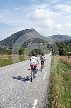 Cycling tourists going a scenic road in Norway in summer