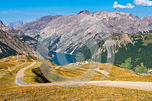 Cycling trail in the bike park in Livigno, with the view on the Lake Livigno in the middle of the Italian Alps.