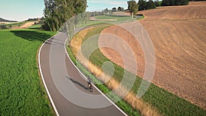 Cycling training. Road cyclist riding bicycle uphill, doing intense endurance cycling training, preparing for mountain bike race.