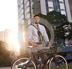 Cycling is the way to go. a businessman commuting to work with his bicycle.