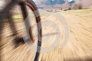 Cycling wheel, motion blur and fitness in nature, countryside and training of triathlon, sports and power. Closeup