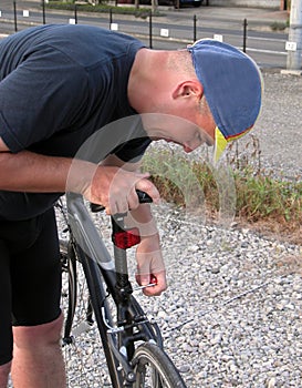 Cyclist adjusting the saddle