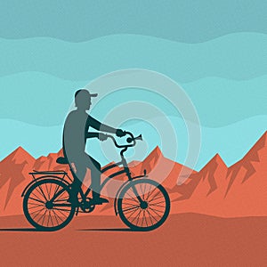 Cyclist on a background of red mountains