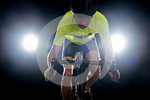 Cyclist backlit on a black background. Road safety tailgating concept