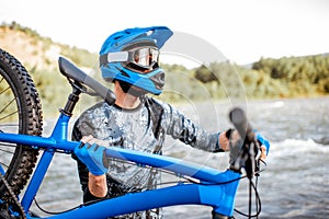 Cyclist with bicycle on the mountains