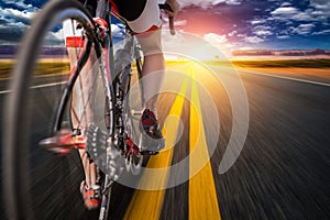 Cyclist on bike path, view from the rear wheel