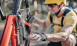 Cyclist checking chainwheel defect