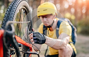 Cyclist checking chainwheel defect