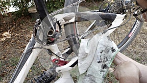 Cyclist cleans dirty bike