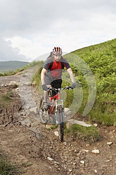 Cyclist On Countryside Muddy Track