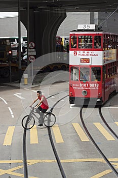 Cyclist crossing tram tracks in Hong Kong