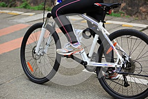 Women cyclist cycling mountain bike on forest trail